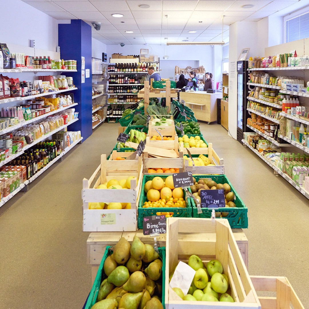 A look inside the MILA mini market with over 800 products. In the centre, many baskets of fresh fruit and vegetables