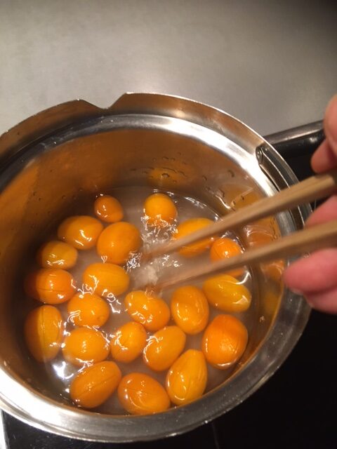 Kumquats köcheln in Zuckersirup